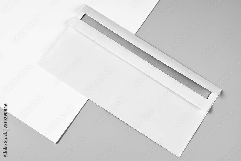 Blank Letterhead or Sheet of Paper and Envelope over Grey Background Blank Letterhead or Sheet of Paper and Envelope over Grey Background