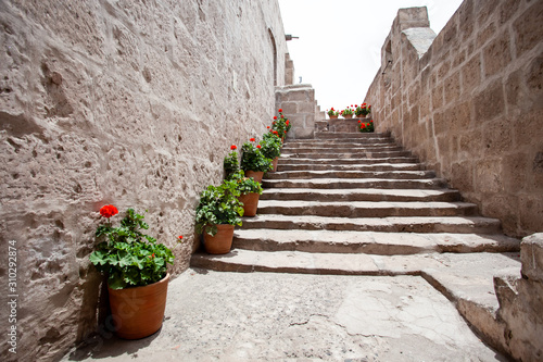 Fototapeta Naklejka Na Ścianę i Meble -  Stone stairs, along the stairs the monastery of Saint. Catalina, Arequipa, Peru