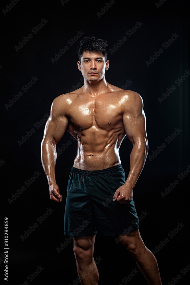 Fototapeta premium Athlete bodybuilder. Strong and fit man. Sporty muscular guy on black background. Sport and fitness motivation. Individual sports recreation.