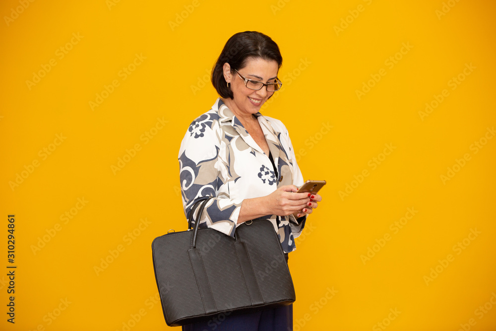 Shot of an attractive mature businesswoman working with her mobile phone Shot of an attractive mature businesswoman working with her mobile phone