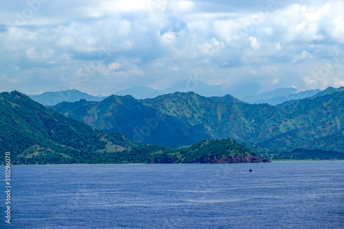 The hazy and mountainous coastline of the Caribbean Island of Haiti as a cruise ship sails by.