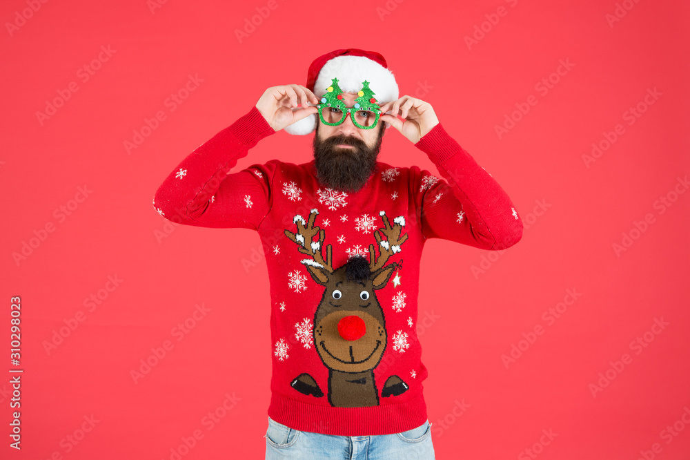 Hipster bearded man photo booth props red background. Christmas celebration ideas. Winter style. Happy new year celebration. Join holiday celebration. Winter party outfit. Sweater with deer