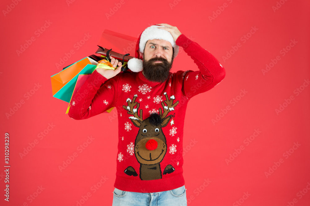 Seasonal sale. Shopping hobby. Take it all. Man on winter shopping. Guy wear knitted sweater and hat carry shopping bags. Bearded hipster customer. Consumerism concept. Wholesale and retail Seasonal sale. Shopping hobby. Take it all. Man on winter shopping. Guy wear knitted sweater and hat carry shopping bags. Bearded hipster customer. Consumerism concept. Wholesale and retail
