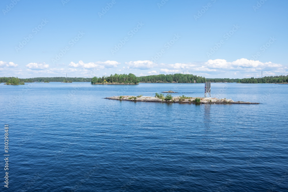Beautiful view from the deck of the cruise ship going up the Lake Saimaa, Lappeenranta, Finland on a warm sunny day.
