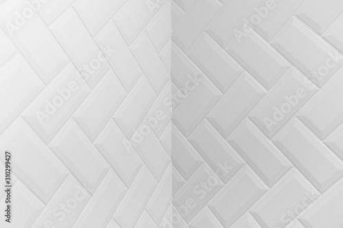 Internal angle of beveled white matt ceramic tiles pattern herringbone on wall. © vladdeep
