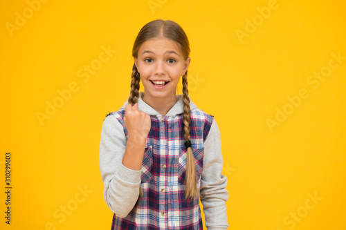 she got power. childhood happiness. happy childrens day. small girl checkered jacket. autumn time. hipster girl yellow background. happy school girl casual style. kid fashion. child cute blond hair