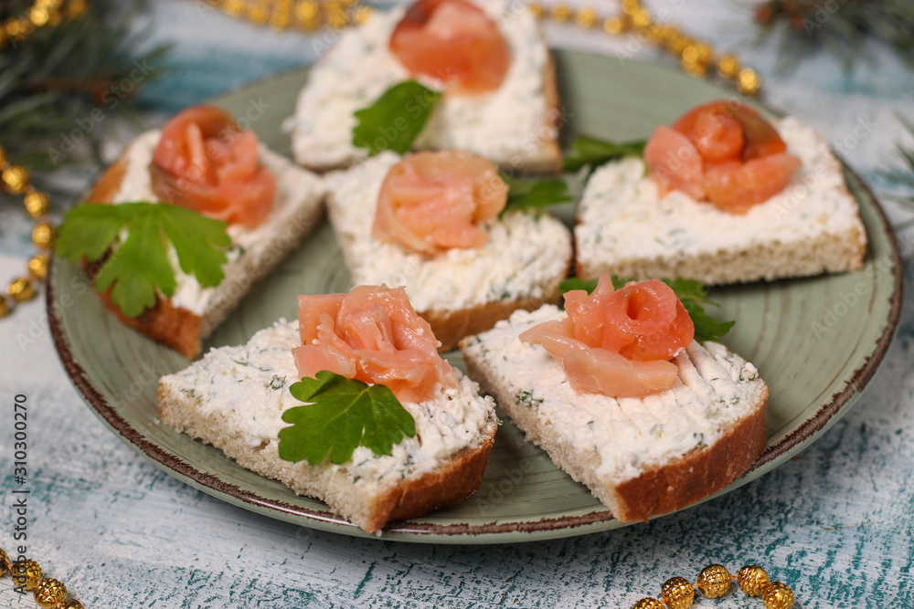 Homemade holiday salmon sandwiches in the form of a rose on a plate close-up Homemade holiday salmon sandwiches in the form of a rose on a plate close-up