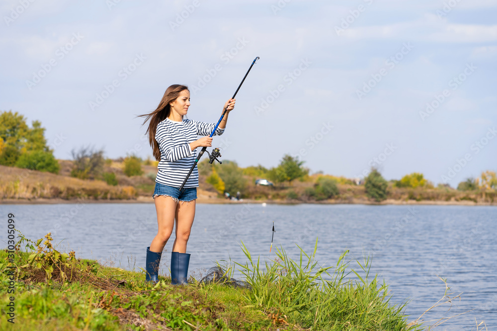 Beautiful young girl fishes on the lake. Beautiful young girl fishes on the lake.
