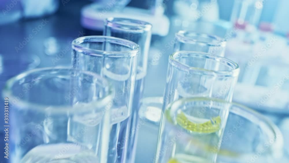 Pharmaceutics Laboratory: Rows of Test Tubes Filled with Experimental Drug for Medical Research and Analysis. Product Line with Sample Tubes Filled DNA Study Fluid Solution. Moving Close-up Macro