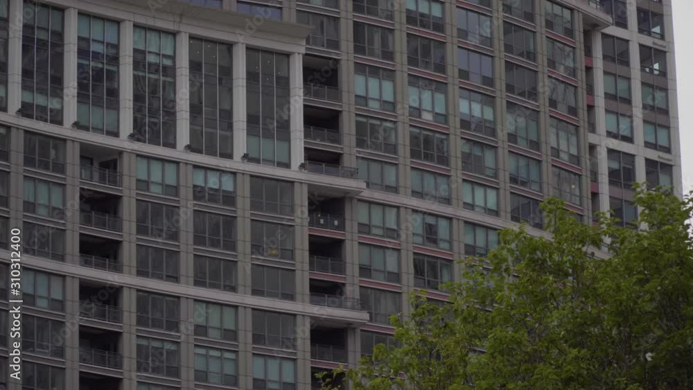 Typical day time generic exterior establishing shot of an urban luxury apartment building in day time DX. Lock down scene setting Typical day time generic exterior establishing shot of an urban luxury apartment building in day time DX. Lock down scene setting