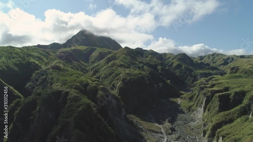 Aerial view mountains covered with green vegetation, trees in vicinity volcano Pinatubo. Slopes of mountains, sky and clouds. Cordillera region. Luzon, Philippines. photo