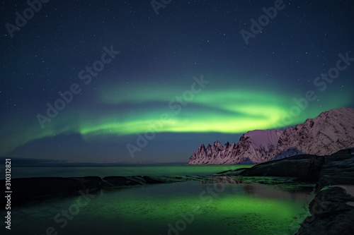 Northern lights  Aurora Borealis  Devil Teeth mountains in the background  Tungeneset  Senja  Norway