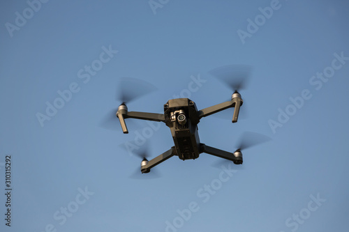 Flying quadrocopter drone in the sky. Aerial photography. © Amir