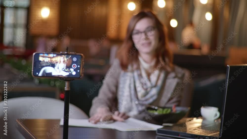 modern work, an attractive woman, a successful blogger leads live broadcasting content on proper nutrition for his vlog while relaxing in an expensive restaurant modern work, an attractive woman, a successful blogger leads live broadcasting content on proper nutrition for his vlog while relaxing in an expensive restaurant