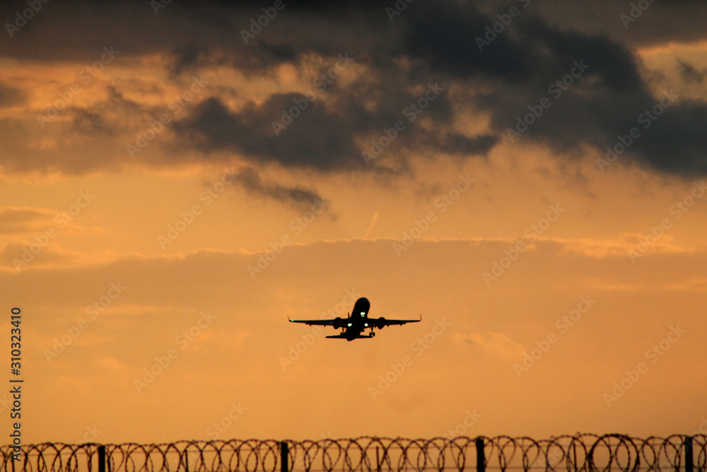 Plane taking off during sunset Plane taking off during sunset