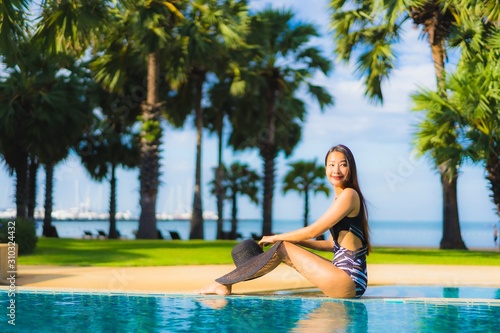 Portrait beautiful young asian women happy smile relax around swimming pool © siraphol