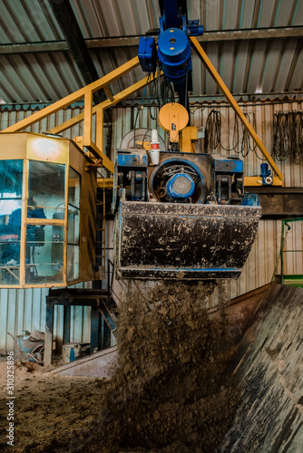 Plant for the production of bricks from clay. Plant for production building material with ready brick, construction industrial. Production of bricks on plant. Workflow, close-up. Many bricks