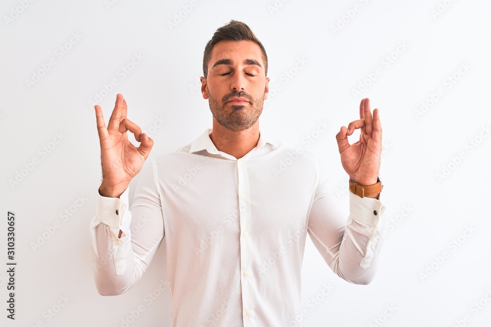 Young handsome business man wearing elegant shirt over isolated background relax and smiling with eyes closed doing meditation gesture with fingers. Yoga concept. Young handsome business man wearing elegant shirt over isolated background relax and smiling with eyes closed doing meditation gesture with fingers. Yoga concept.