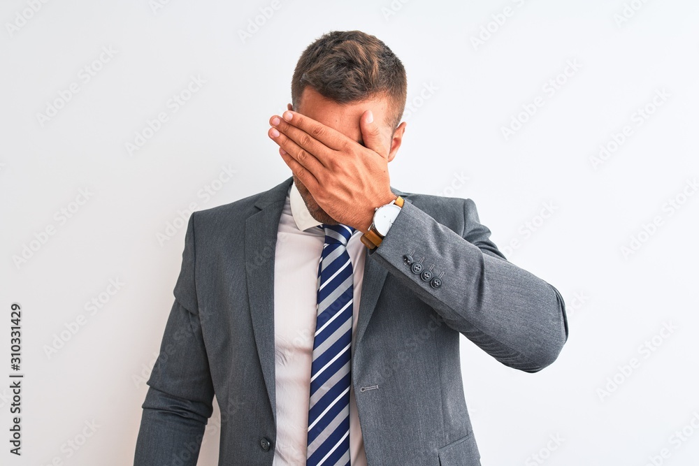 Young handsome business man wearing suit and tie over isolated background covering eyes with hand, looking serious and sad. Sightless, hiding and rejection concept Young handsome business man wearing suit and tie over isolated background covering eyes with hand, looking serious and sad. Sightless, hiding and rejection concept
