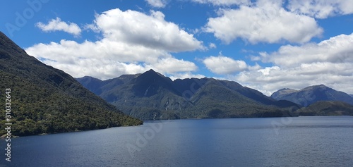 Doubtful Sound Fjord, Doubtful Sound / New Zealand - December 18, 2019: The Majestic Mountains and Waterfalls of the Doubtful Sound Fjord, New Zealand photo