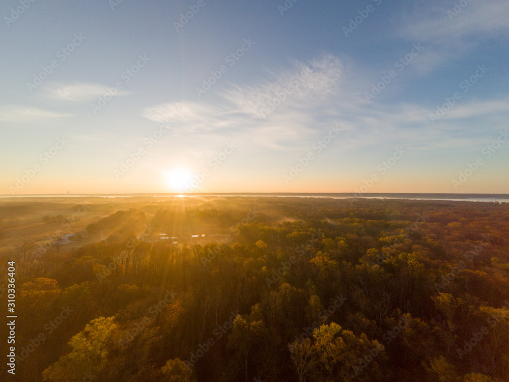 Colorful Sunrise over Forest and Countryside. Aerial Drone View