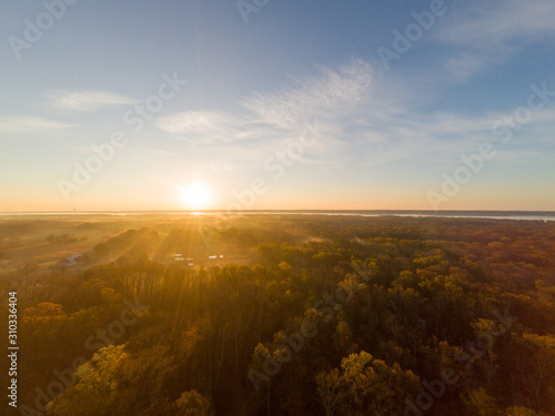 Colorful Sunrise over Forest and Countryside. Aerial Drone View