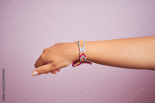 Model arm with beautiful handmade colorful bracelet on wrist
