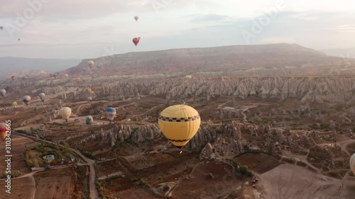 A balloon flies over Cappadocia, shooting from a drone in 4K