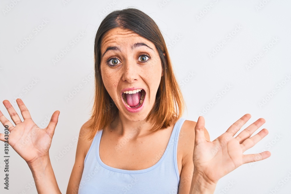 Beautiful redhead woman standing over isolated background very happy and excited, winner expression celebrating victory screaming with big smile and raised hands Beautiful redhead woman standing over isolated background very happy and excited, winner expression celebrating victory screaming with big smile and raised hands