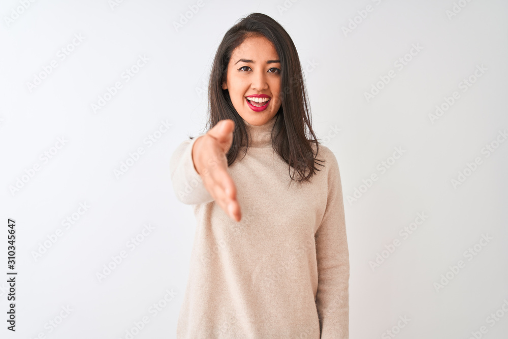 Beautiful chinese woman wearing turtleneck sweater standing over isolated white background smiling friendly offering handshake as greeting and welcoming. Successful business. Beautiful chinese woman wearing turtleneck sweater standing over isolated white background smiling friendly offering handshake as greeting and welcoming. Successful business.