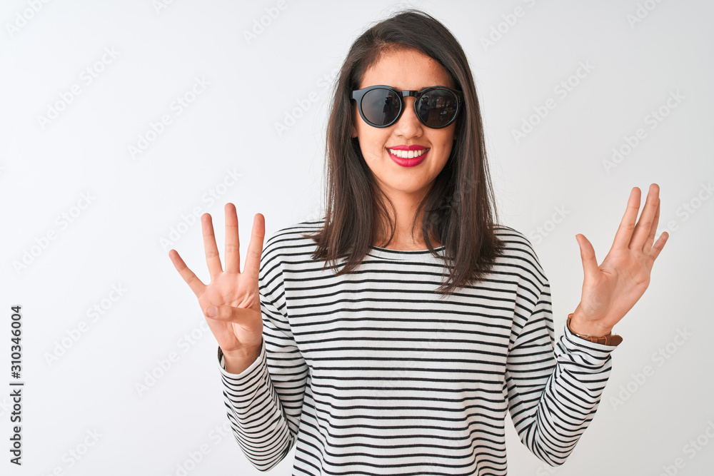 Chinese woman wearing striped t-shirt and sunglasses standing over isolated white background showing and pointing up with fingers number nine while smiling confident and happy. Chinese woman wearing striped t-shirt and sunglasses standing over isolated white background showing and pointing up with fingers number nine while smiling confident and happy.