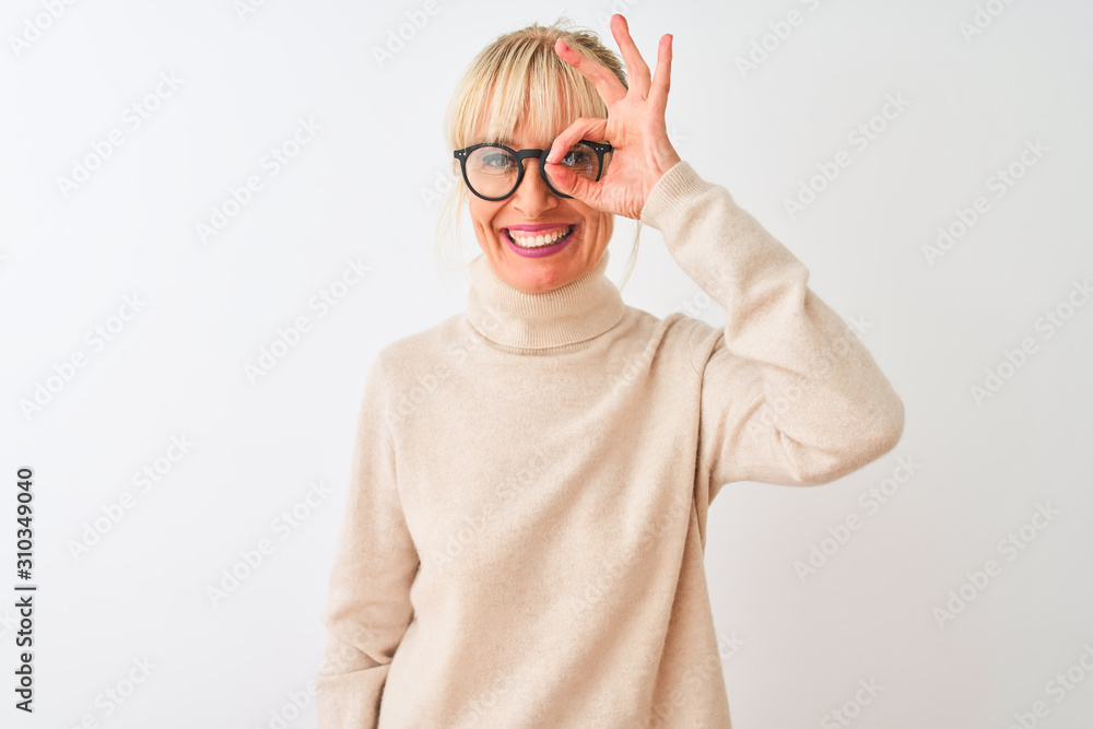 Middle age woman wearing turtleneck sweater and glasses over isolated white background doing ok gesture with hand smiling, eye looking through fingers with happy face.