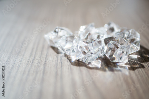 Shiny diamond on wooden background.