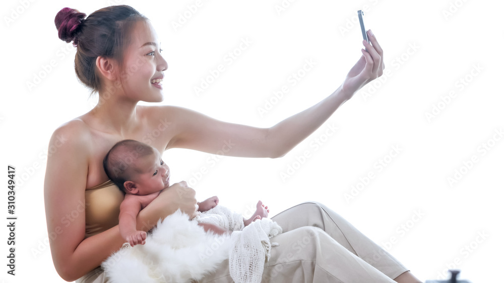 Happy mother taking photos with baby in the room. Happy mother taking photos with baby in the room.