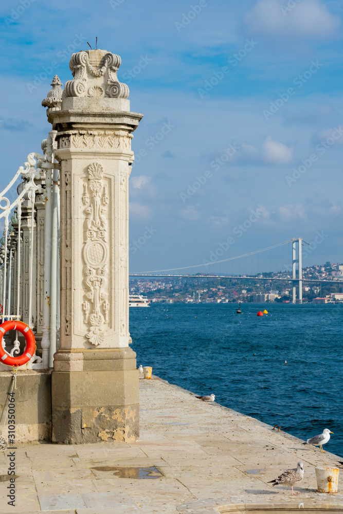 Dolmabahce Palace column and Bosphorus bridge. Istanbul, Turkey
