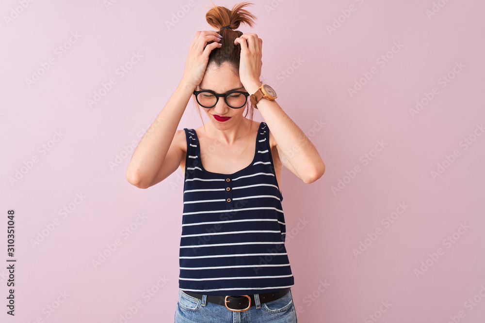 Φωτογραφία Redhead woman with pigtail wearing striped t-shirt standing over isolated pink background suffering from headache desperate and stressed because pain and migraine