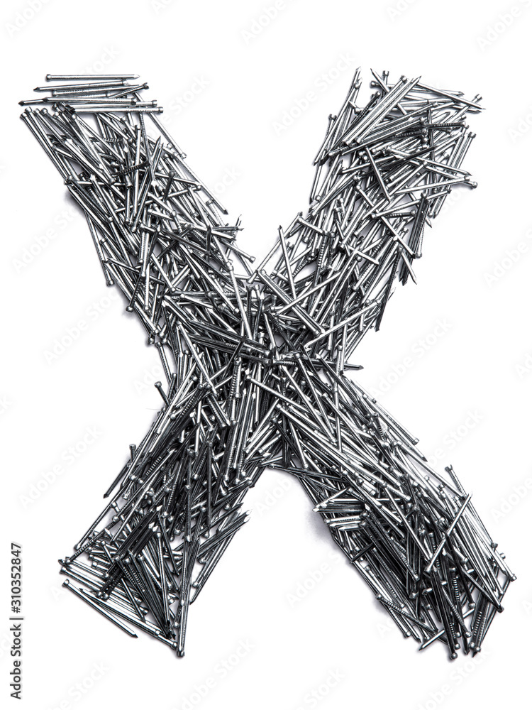 Letter X of the English alphabet from small iron nails on a white isolated background. Industrial pattern of thin nails for fasteners. bright numeral for design. Letter X of the English alphabet from small iron nails on a white isolated background. Industrial pattern of thin nails for fasteners. bright numeral for design.
