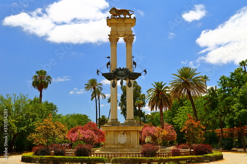 Monument of Christopher Columbus decorated with the prows of two ships and a lion in the garden de Murillo in Seville, capital of Andalusia, Spain,  photo