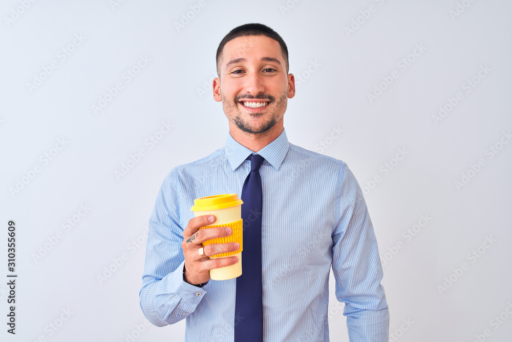 Young business man holding take away coffee over isolated background with a happy face standing and smiling with a confident smile showing teeth Young business man holding take away coffee over isolated background with a happy face standing and smiling with a confident smile showing teeth