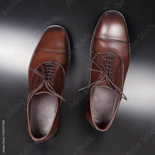 Classic men's brown shoes on dark background
