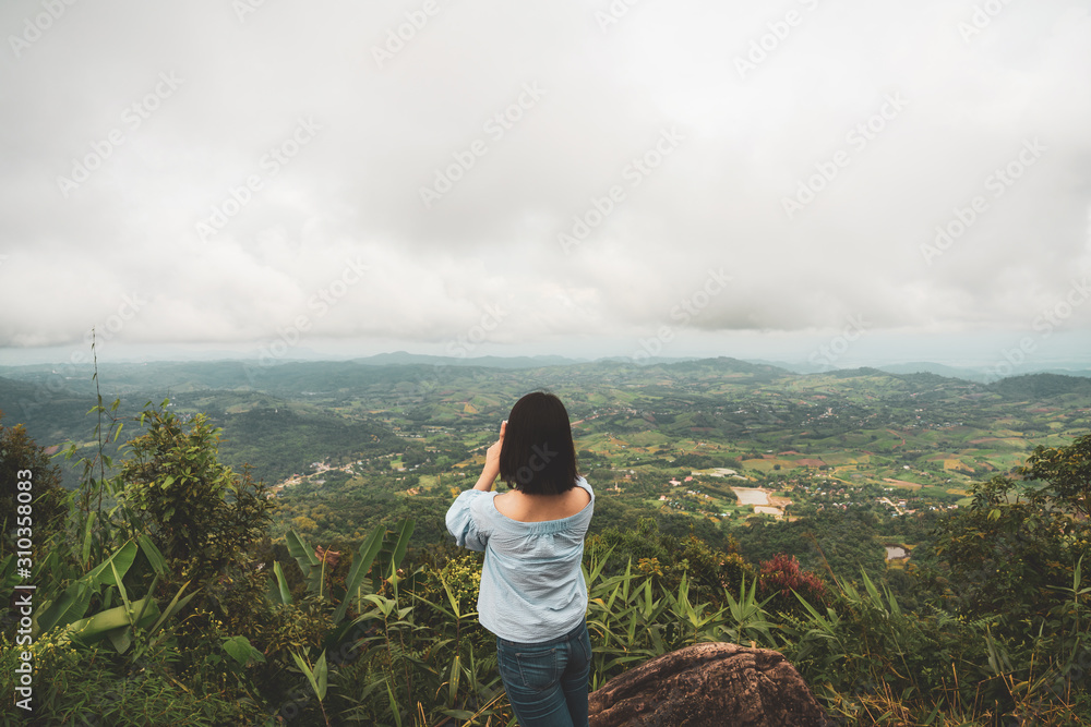 young cute Japanese Asian hipster girl travelling at beautiful sky  mountains scenery park hiking garden views at Kanchanaburi Thailand guiding  idea for female backpacker woman women backpacking