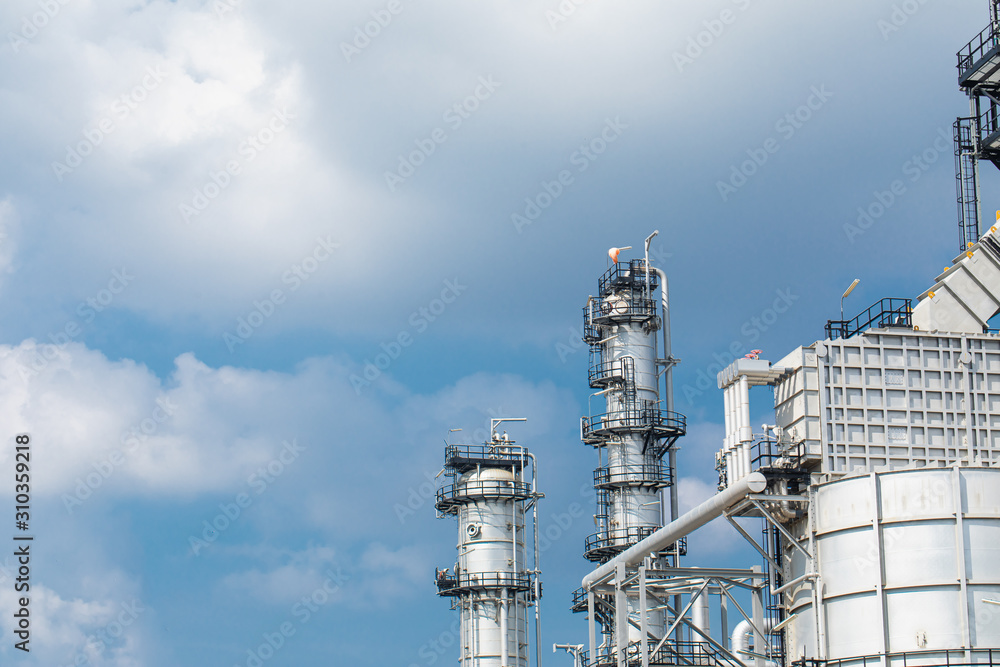 Oil and gas industrial,Oil refinery plant form industry,Refinery factory oil storage tank and pipeline steel blue sky background Oil and gas industrial,Oil refinery plant form industry,Refinery factory oil storage tank and pipeline steel blue sky background