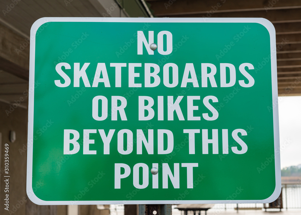 No Skateboards or Bikes Beyond This Point Sign