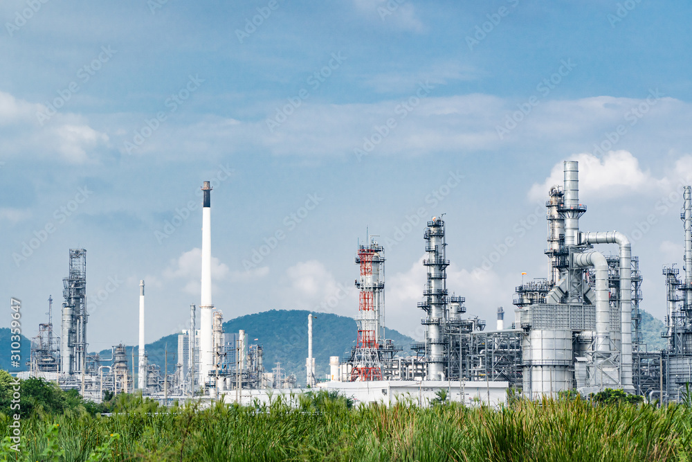 Oil and gas industrial,Oil refinery plant form industry,Refinery factory oil storage tank and pipeline steel blue sky background