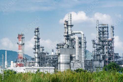 Oil and gas industrial,Oil refinery plant form industry,Refinery factory oil storage tank and pipeline steel blue sky background