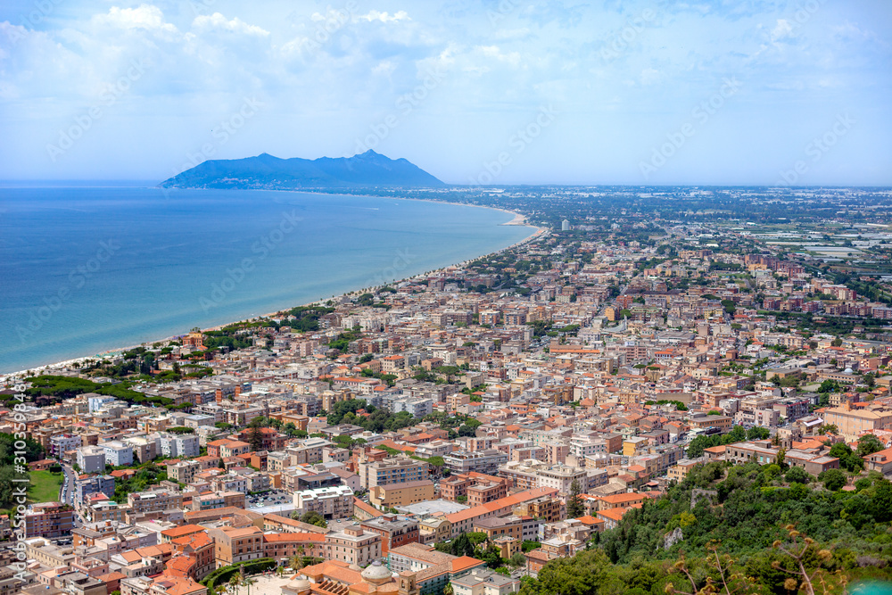 Aerial view of city Terracina on bright sunny day. Circeo promontory and Tyrrhenian sea on background. Terracina, Province of Latina, Lazio, Italy.