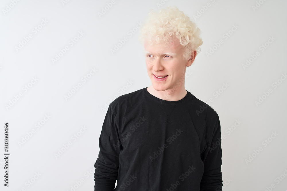 Young albino blond man wearing black t-shirt standing over isolated white background looking away to side with smile on face, natural expression. Laughing confident. Young albino blond man wearing black t-shirt standing over isolated white background looking away to side with smile on face, natural expression. Laughing confident.