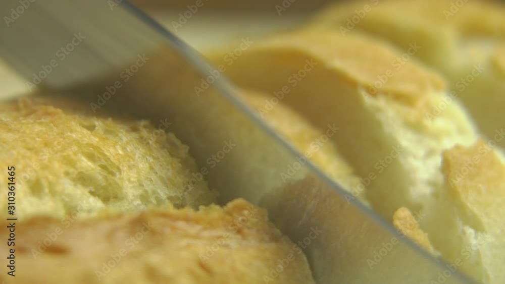 Macro View of Slicing Freshly Baked White Bread with Knife Macro View of Slicing Freshly Baked White Bread with Knife