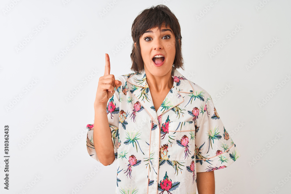 Beautiful woman on vacation wearing summer casual shirt over isolated white background pointing finger up with successful idea. Exited and happy. Number one. Beautiful woman on vacation wearing summer casual shirt over isolated white background pointing finger up with successful idea. Exited and happy. Number one.
