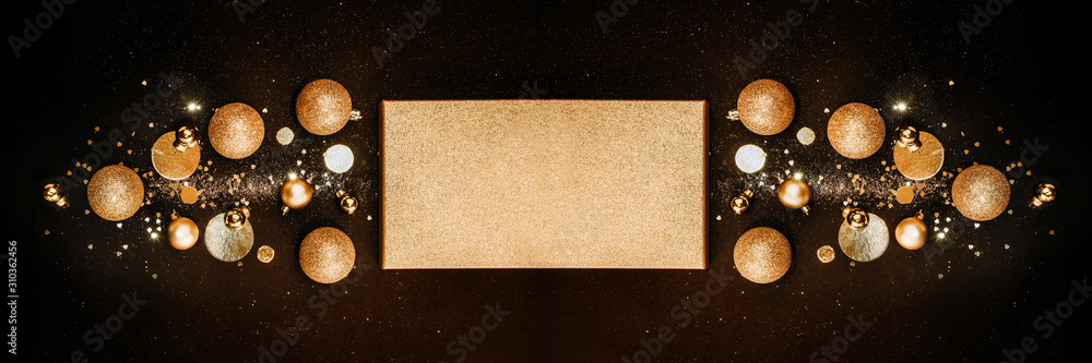 Fototapeta premium Christmas composition. Christmas tree concept with golden decorations, balls, glitters on a black background. background. Christmas, new year concept. Banner Minimalism flat lay